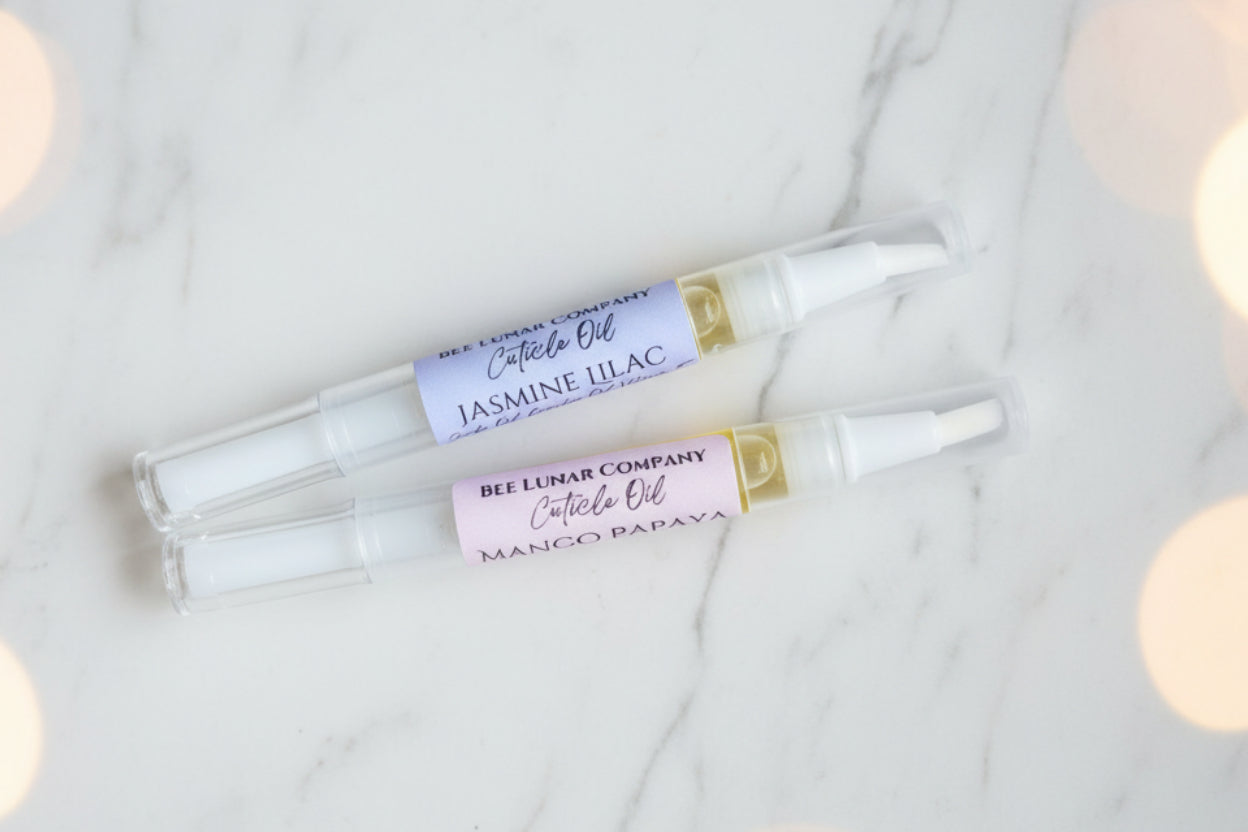 Two small bottles of cuticle oil with droppers, labeled with the brand Bee Lunar Co. and the scent 'Jasmine Haze'.