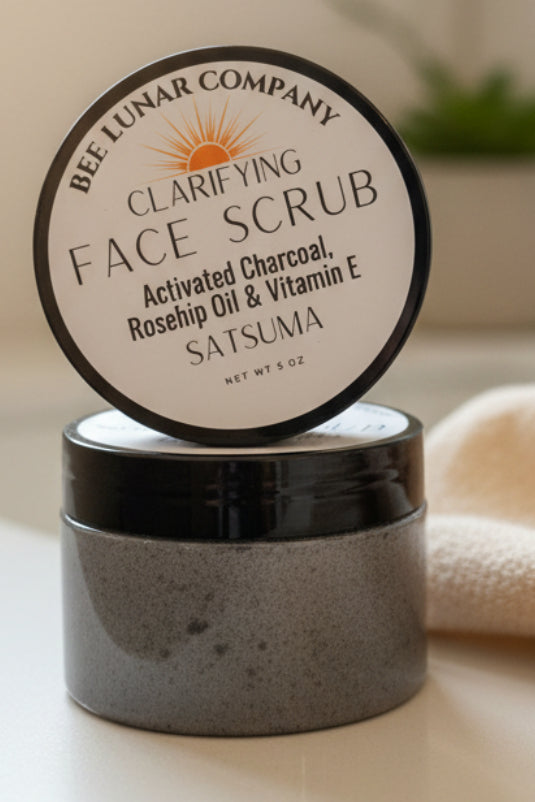 Jar of clarifying face scrub with visible branding on a neutral background