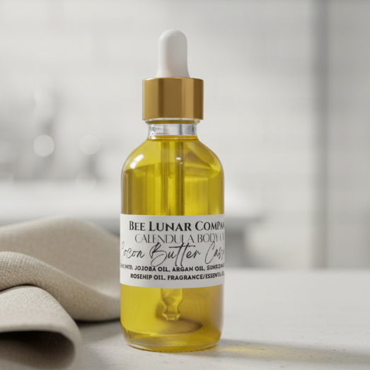 Bottle of Bee Lunar Company body oil on a gray surface