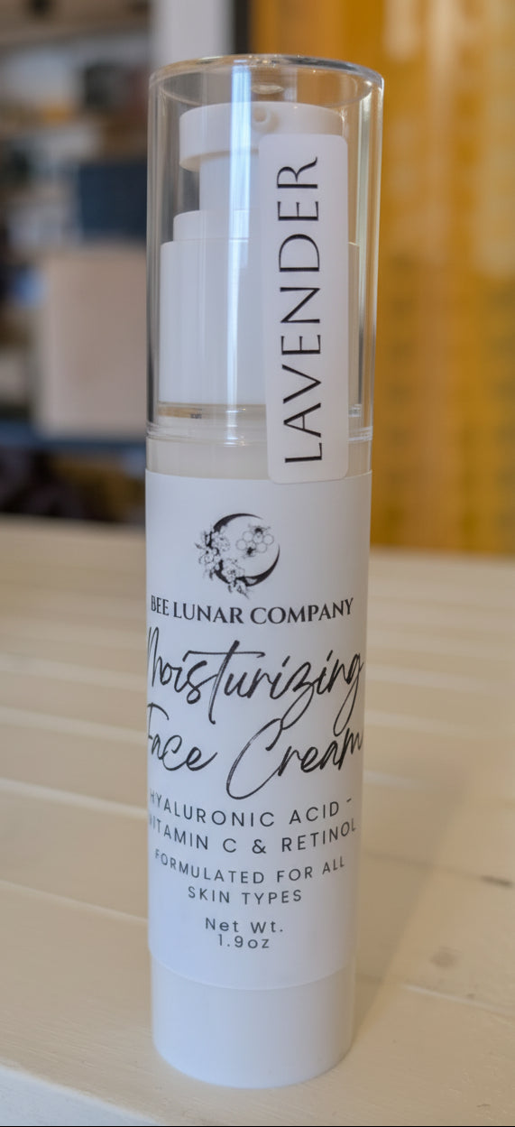 Skincare bottle labeled 'Lavender Moisturizing Face Cream' on a wooden surface with a blurred background